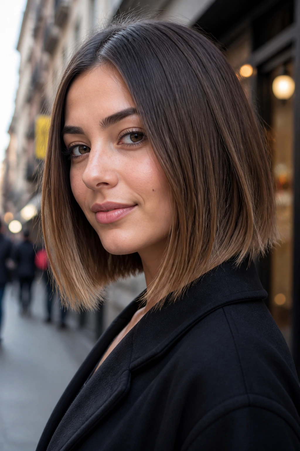 Close-up of a real woman with a razor-cut lob showing textured ends.
