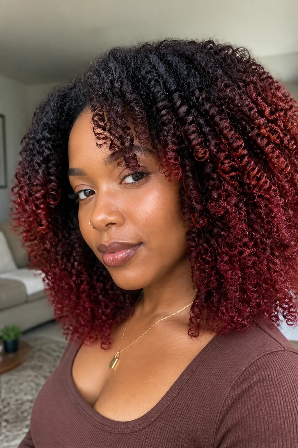 Close-up of a woman with red ombre braid-out and dark roots