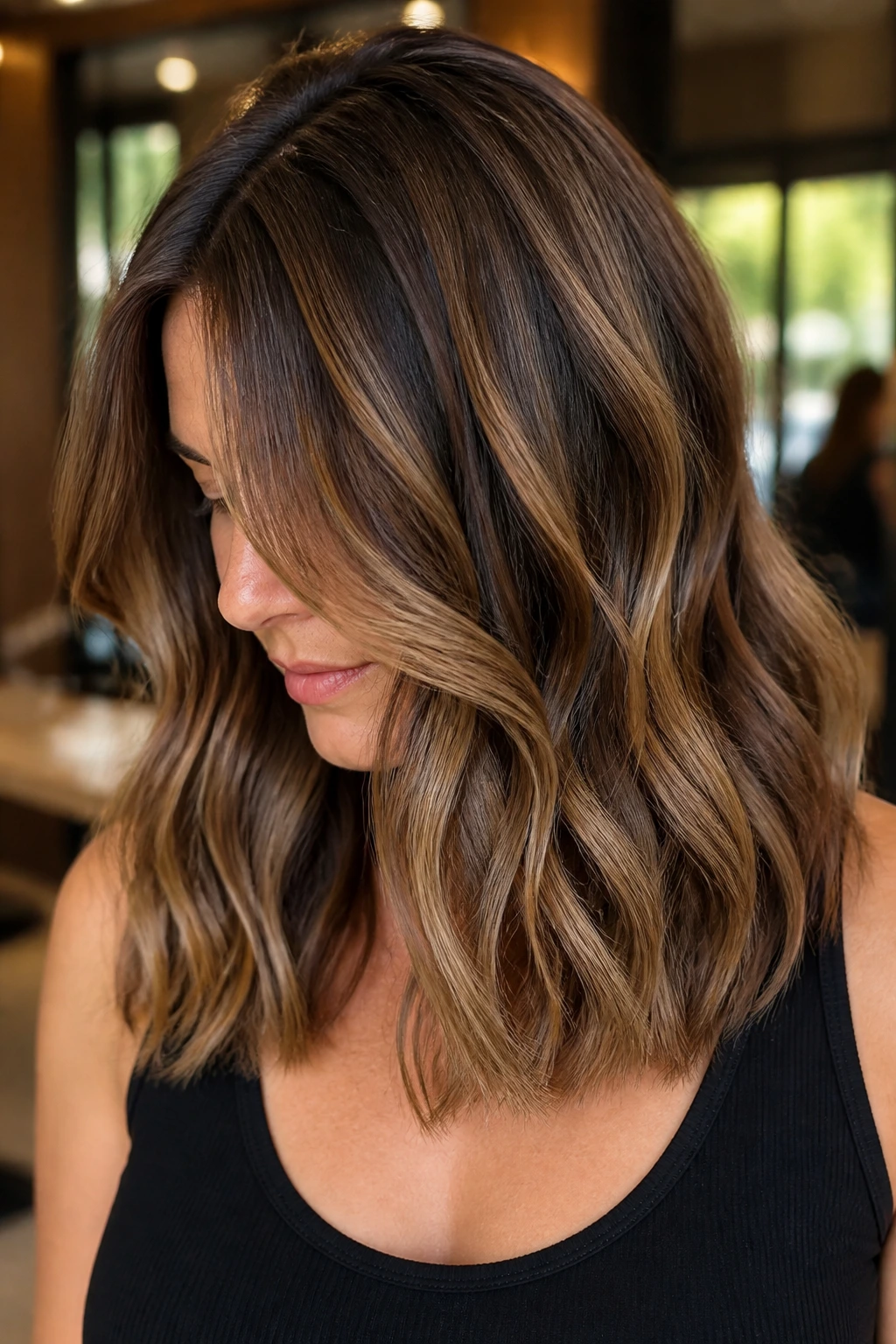 Close-up portrait of a real woman with reverse balayage caramel dimension