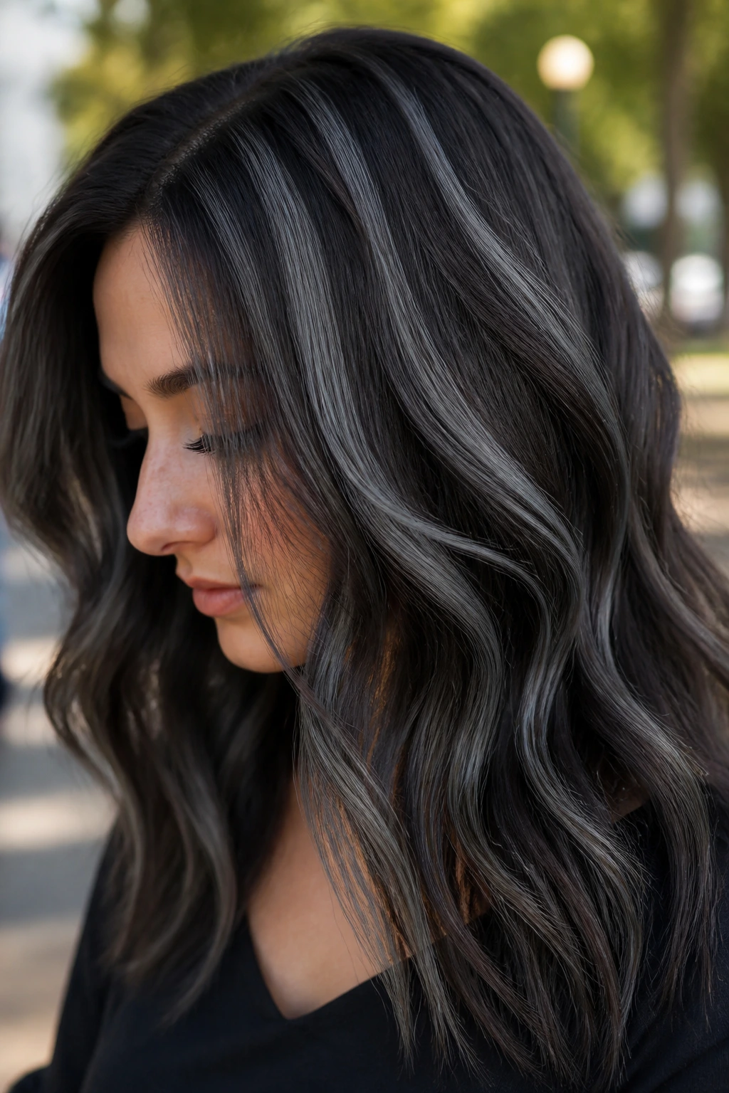Brunette with gray-black ribbon highlights close-up.