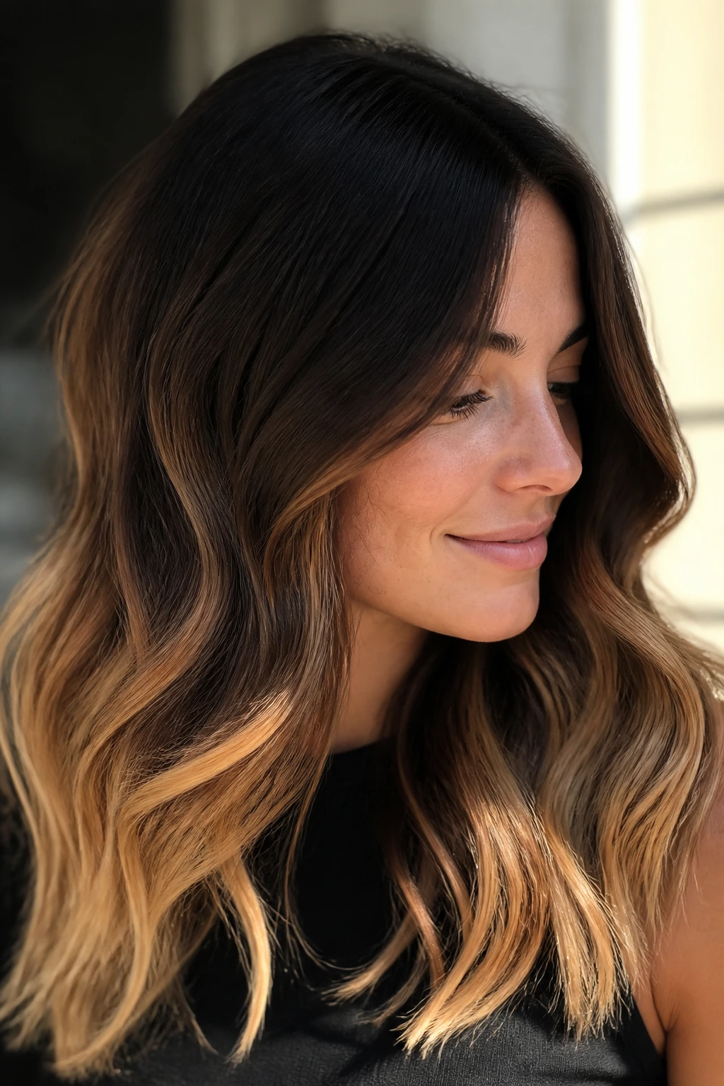 Brunette with dark espresso roots fading to honey caramel ends