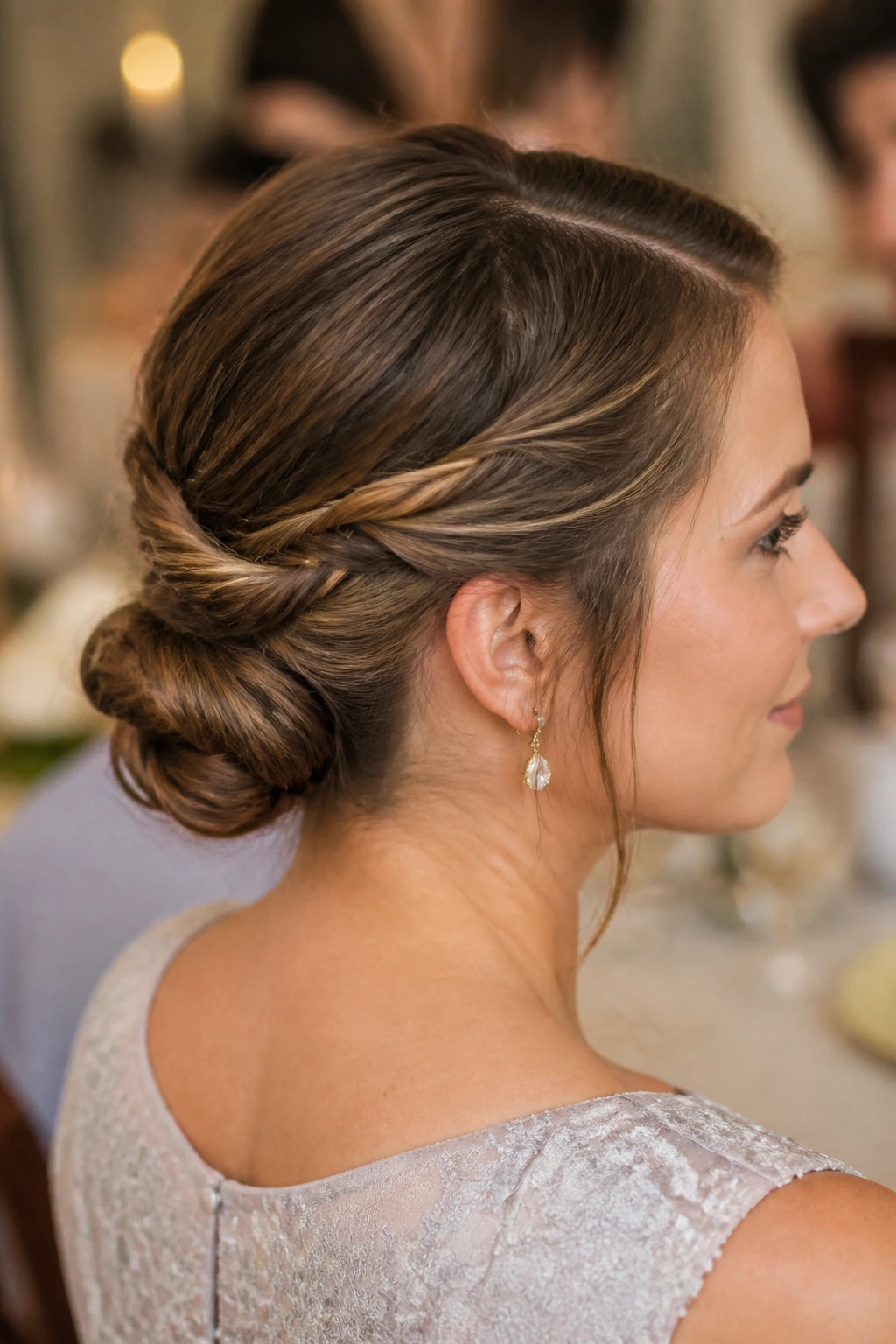 Close-up of a real woman with a rope-braid low bun at the nape