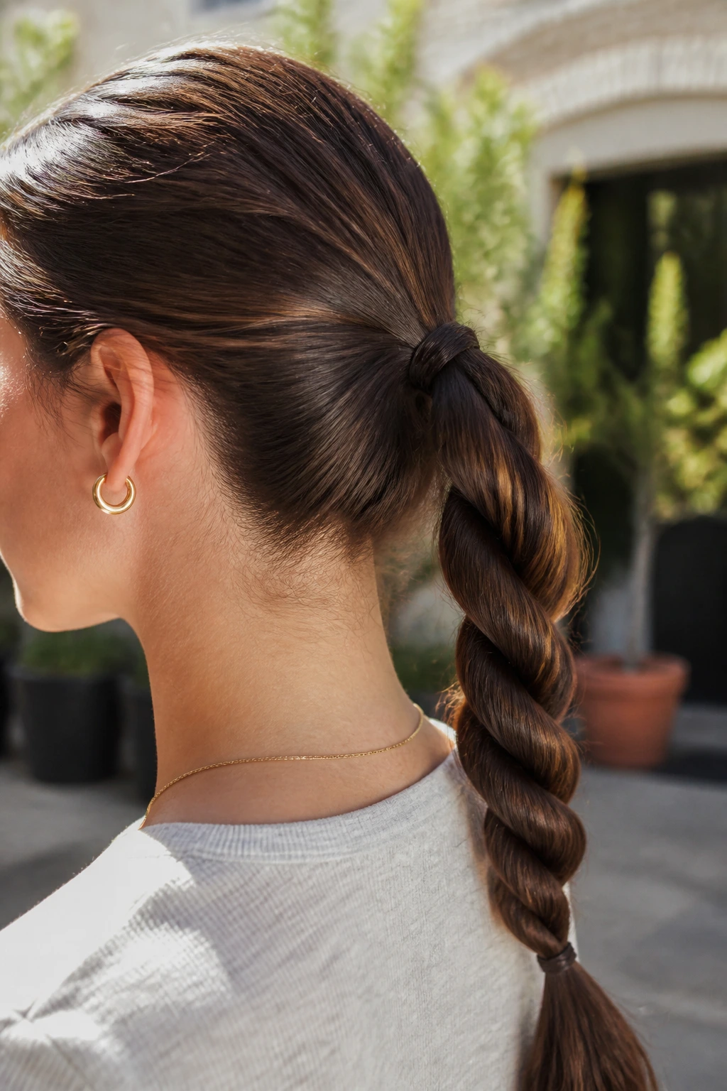 Close-up of a real woman with a rope-braid ponytail