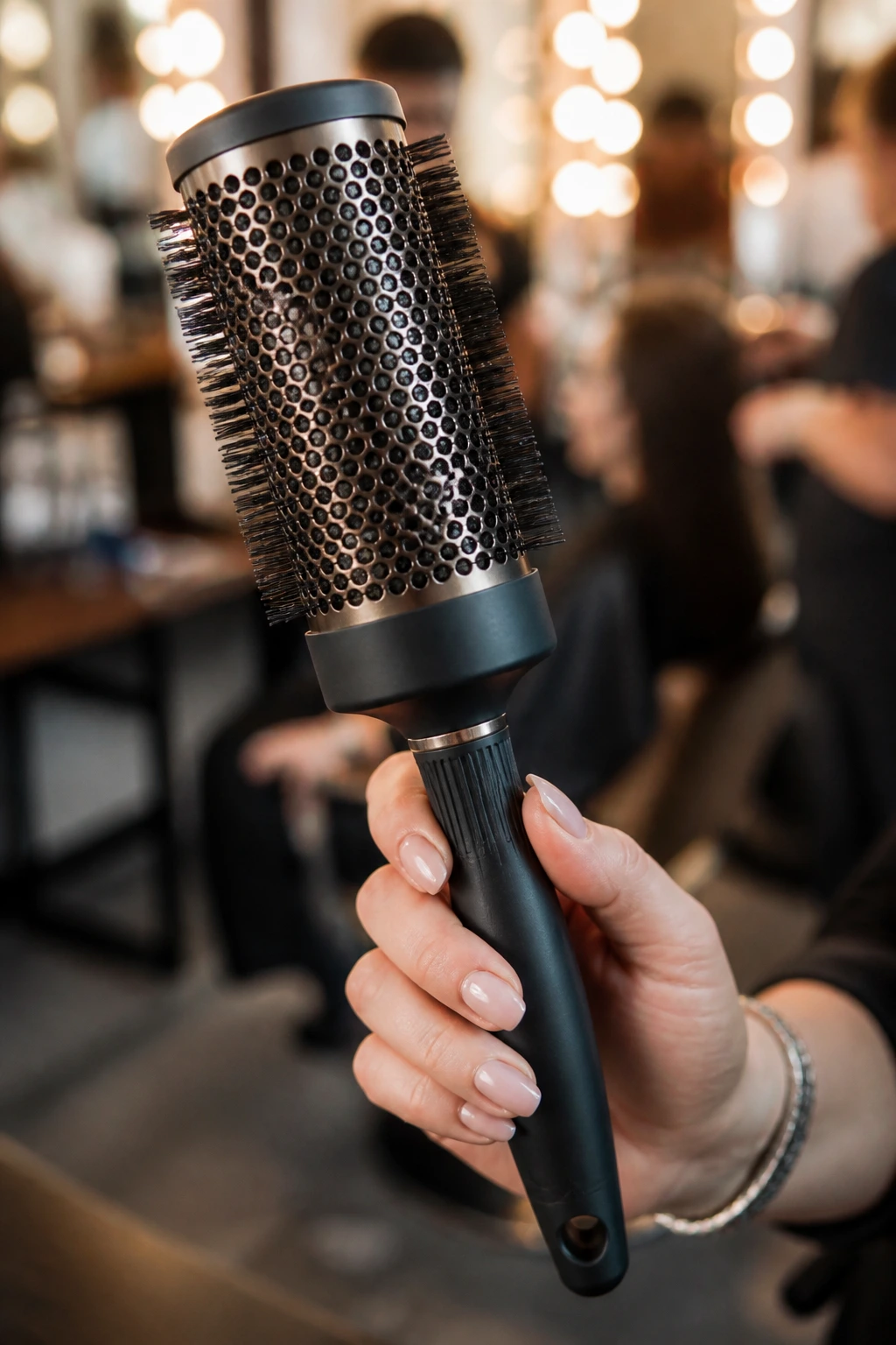 Close-up of a round brush used for smoothing bangs in a salon