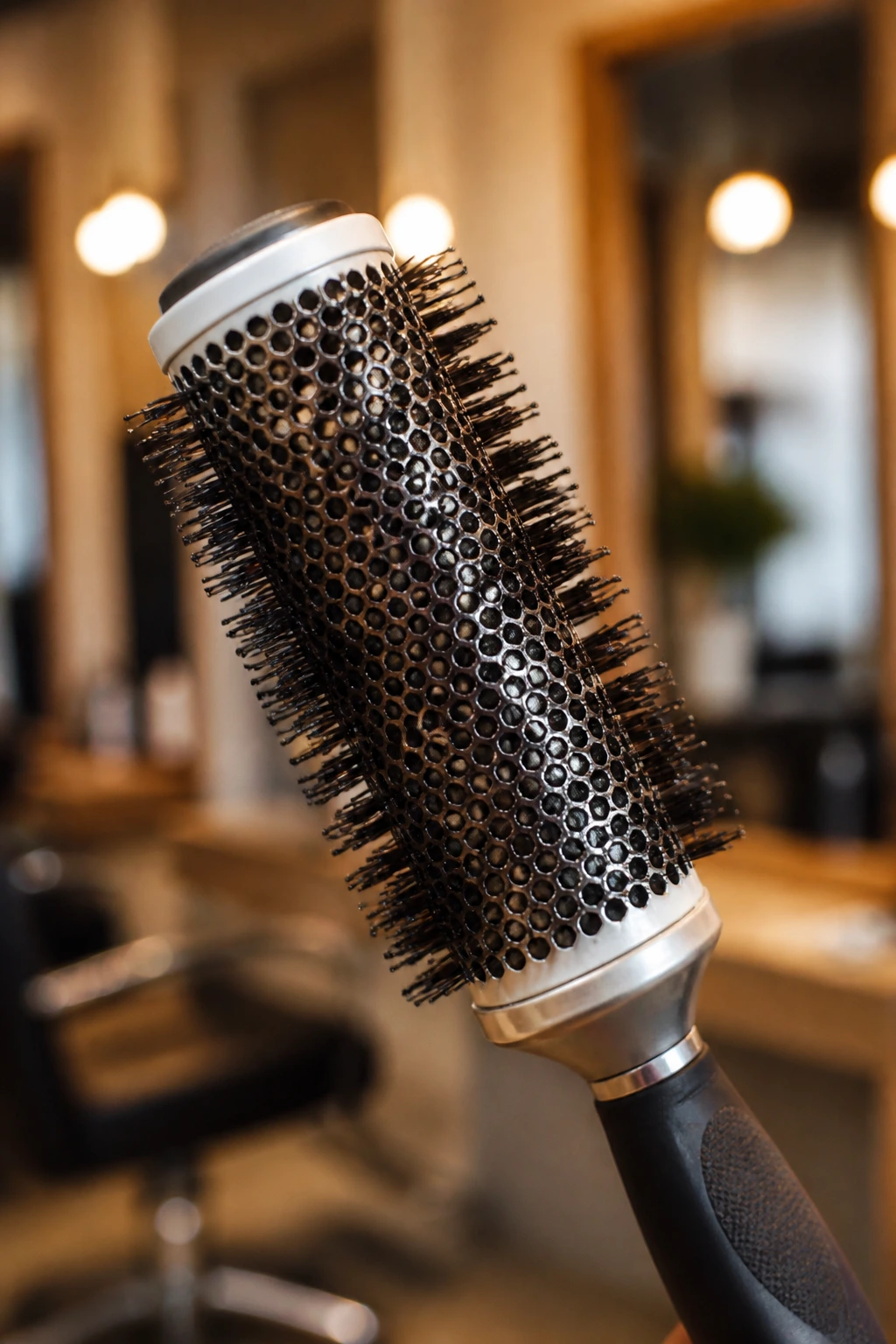 Close-up of a round brush in a salon setting