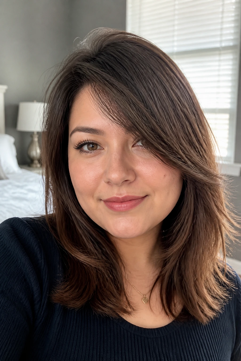 Close-up portrait of a woman with round-face side-swept layers.