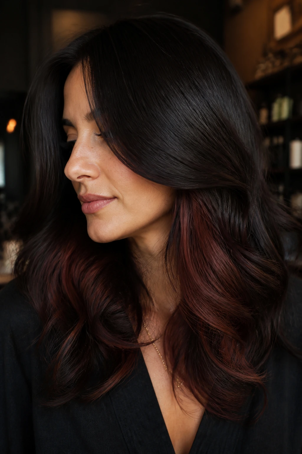 Sable hair showing red-brown underlights in a moody salon setting