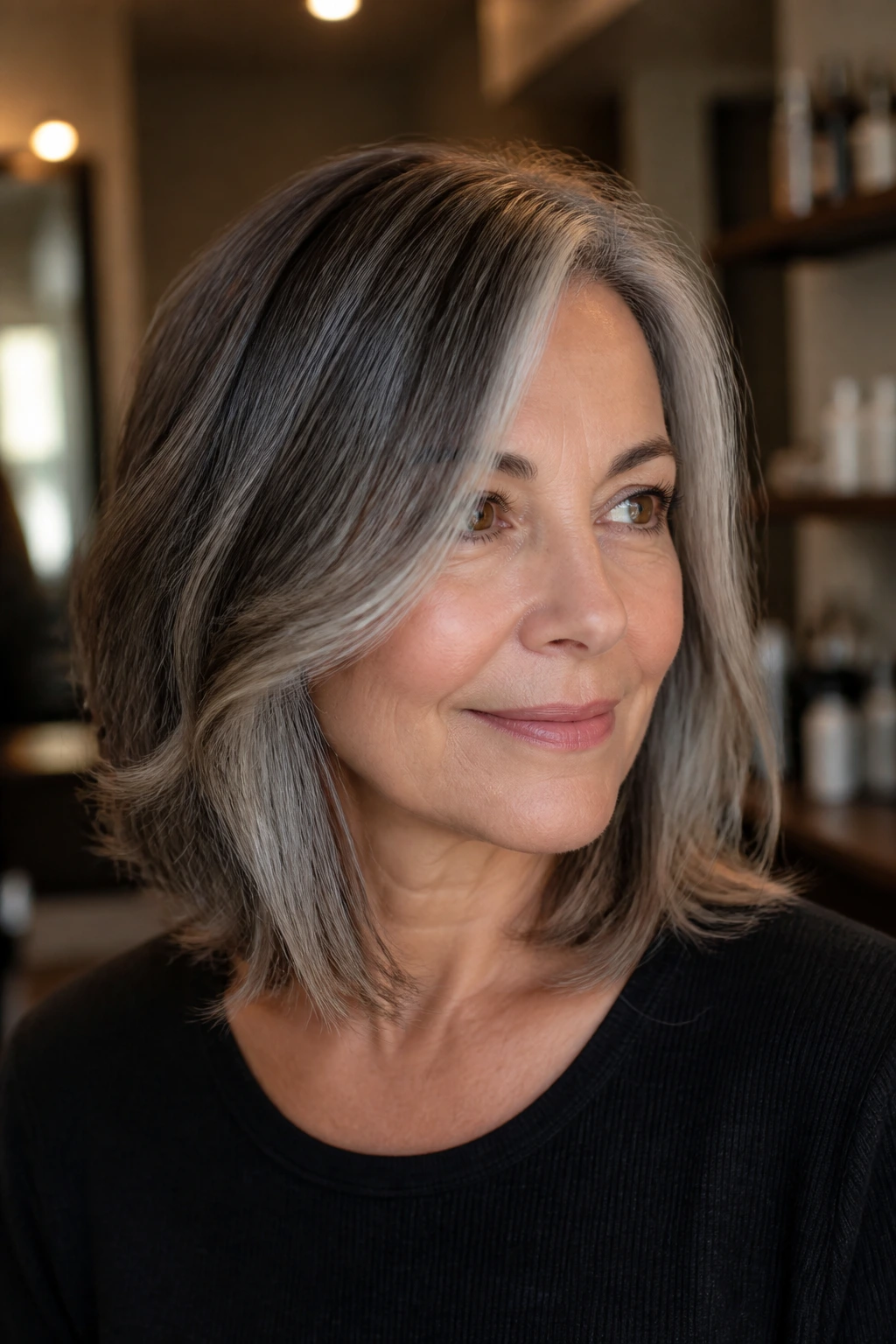 Close-up of a woman with salt-and-pepper lob and shine layers