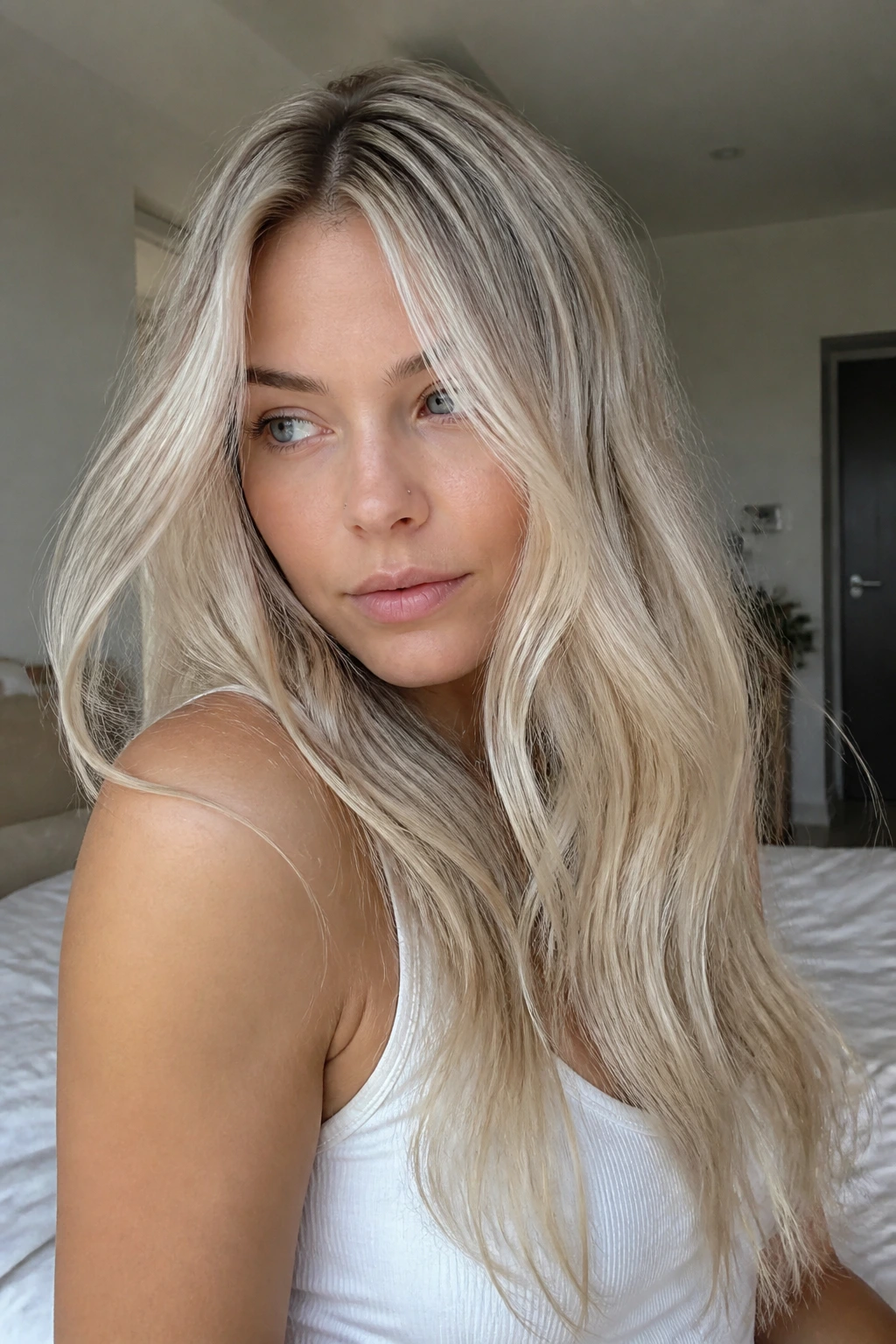 Close-up of a real woman with Scandinavian blonde and mushroom melt at the roots