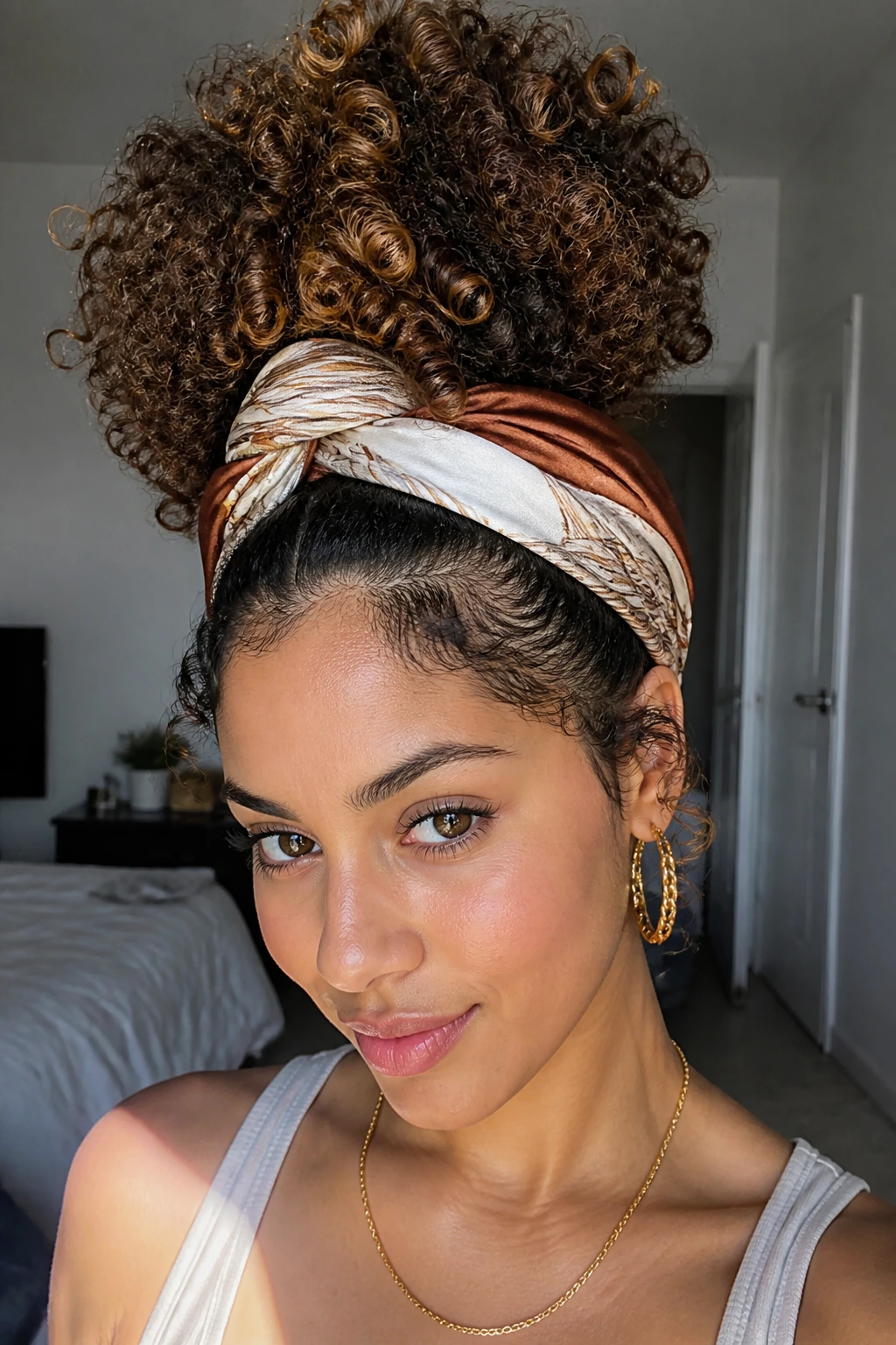 Close-up portrait of a real person with scarf-wrapped pineapple hairstyle and lowlights