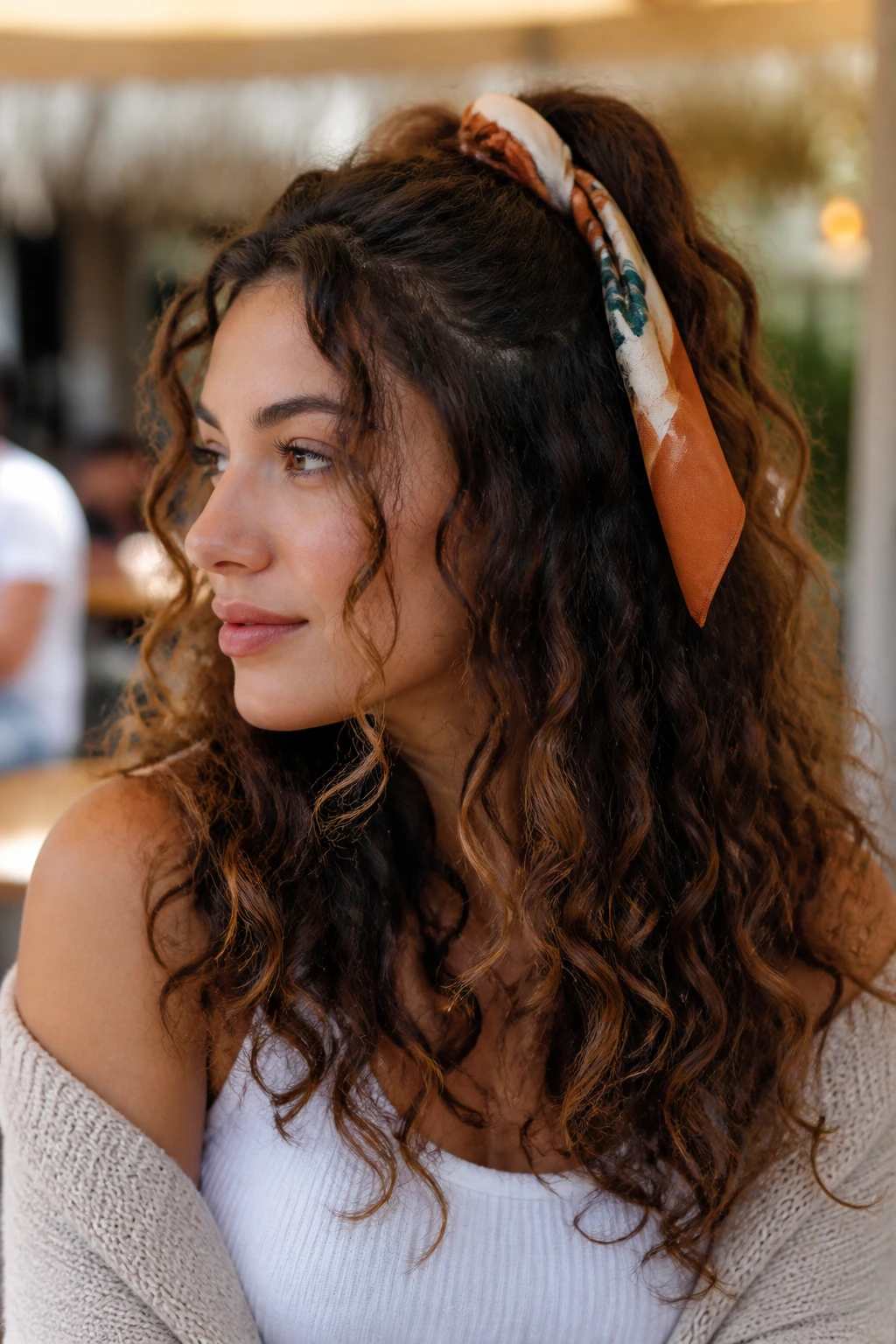 Real woman with scarf-wrapped half pony and loose waves