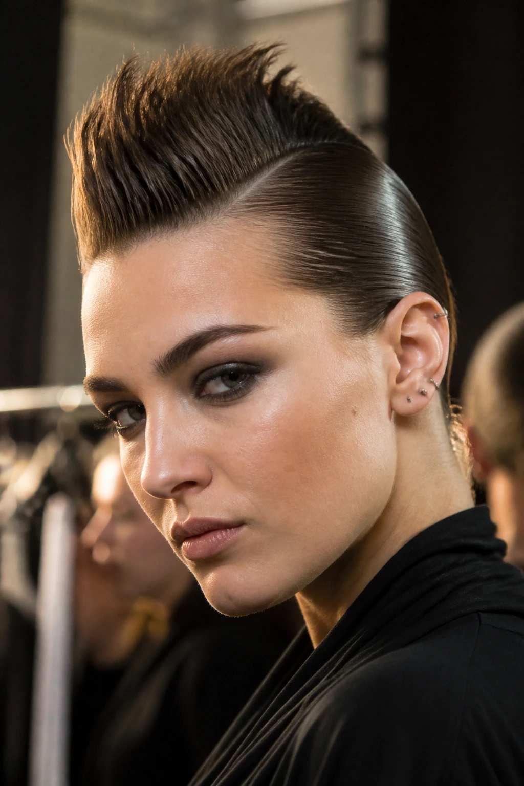 Close-up of a real woman with a sculpted faux hawk featuring a narrow ridge and slick sides.