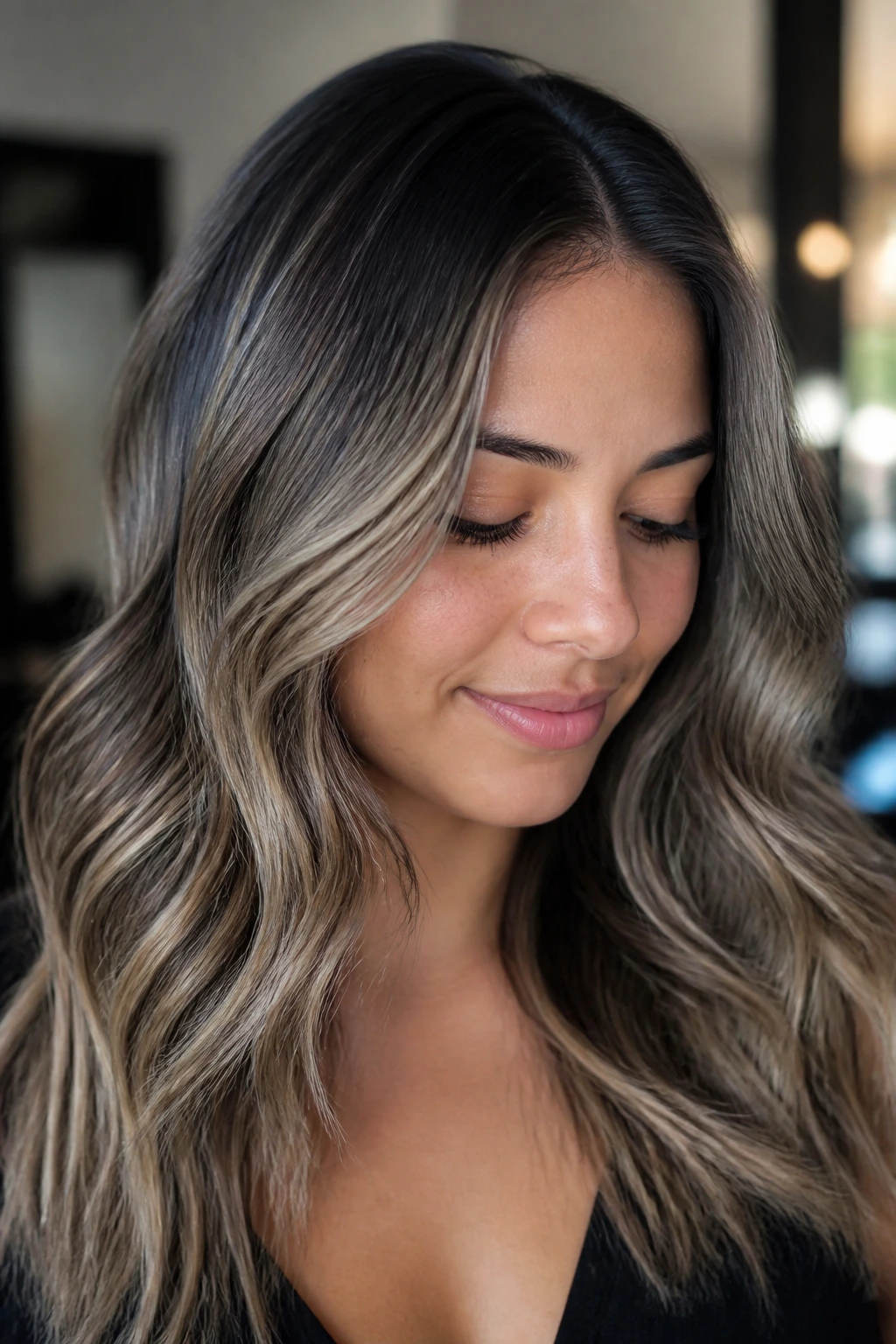 Close-up of a real person with shadow-rooted ash balayage for grow-out.