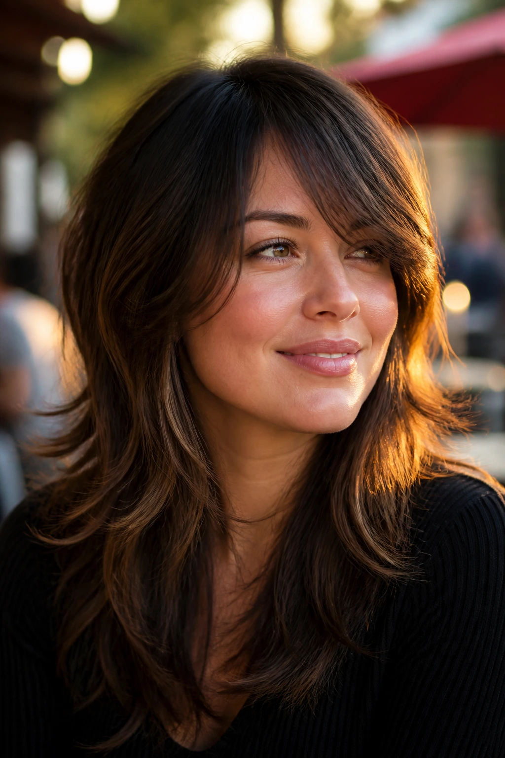 Close-up of a real woman with shag-inflected layers and a soft edge outdoors.