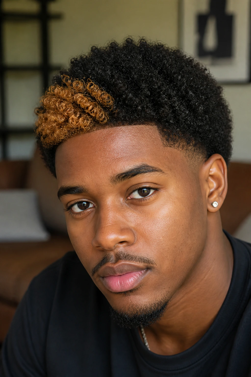 Close-up of a man with short afro and caramel front streak.