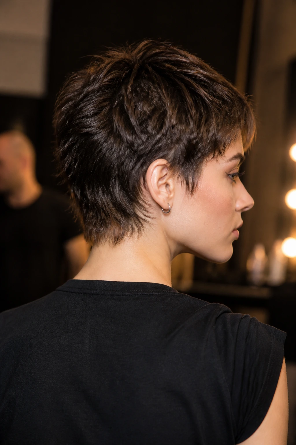 Portrait of a real person with a short mullet and tapered nape, textured top and clean back