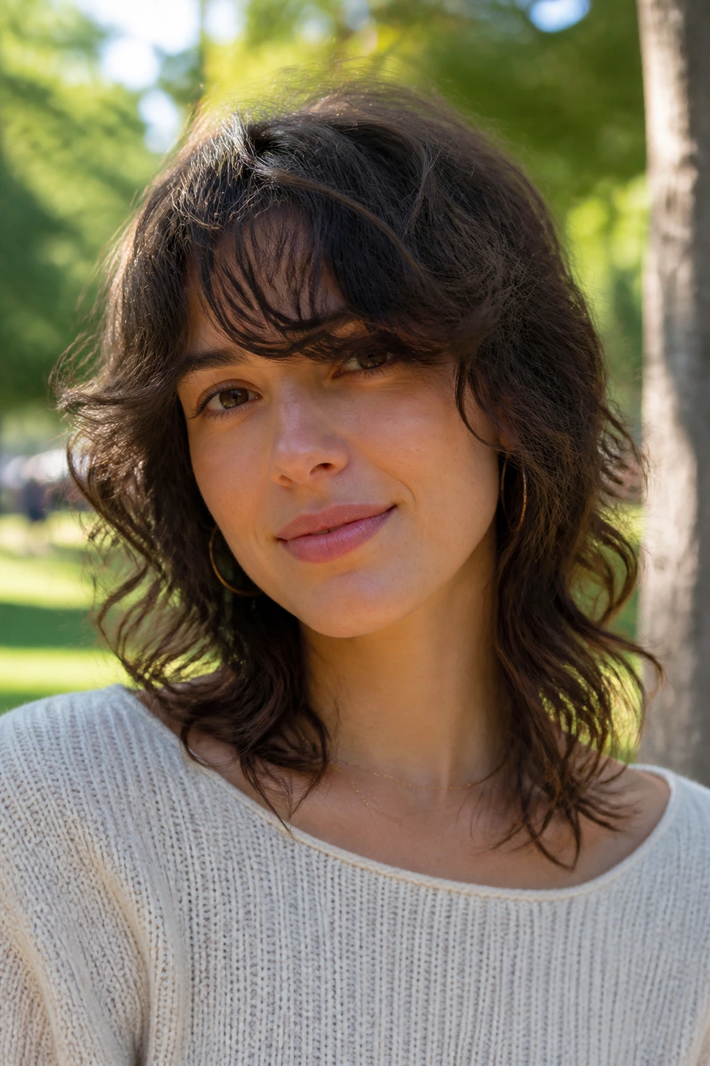 Portrait of a real person with a shoulder-length boho shag and side bangs.