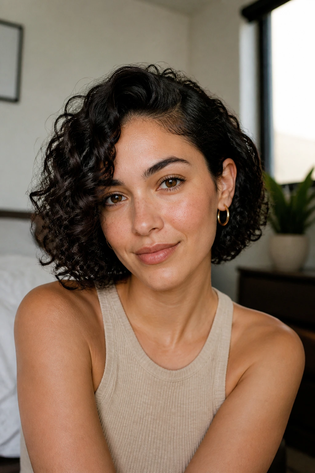 Close-up of a person with a side-parted curly bob framing the face