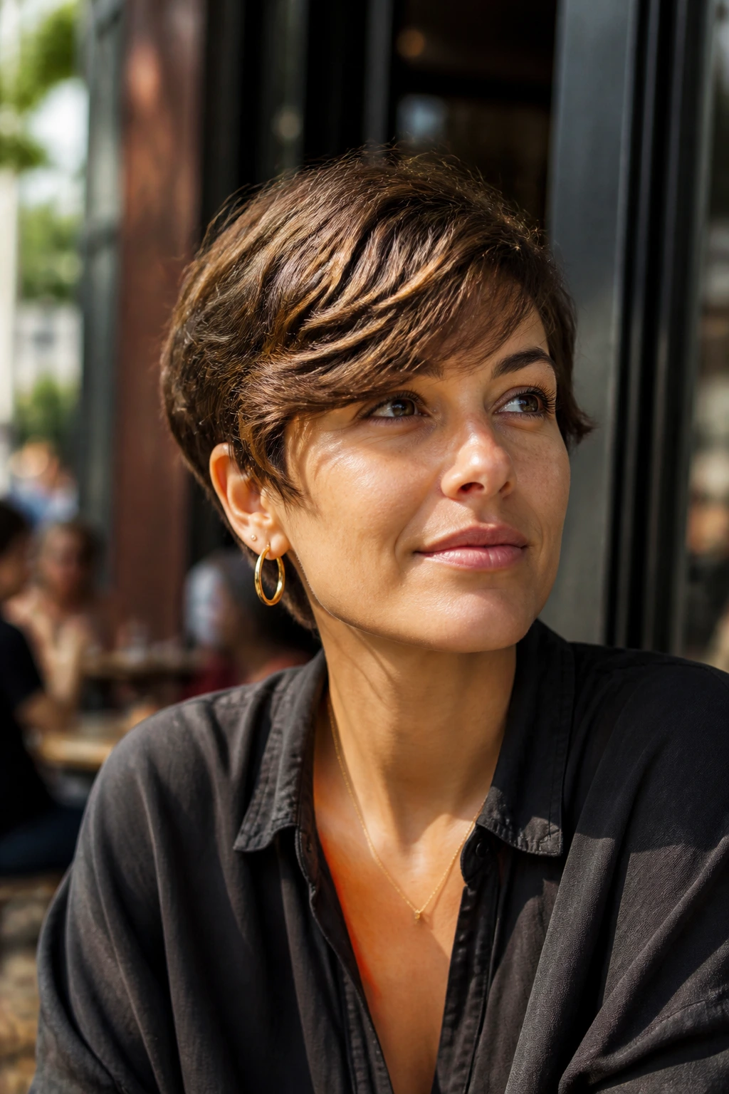 Real woman with side-swept fringe crop in sunlit urban setting