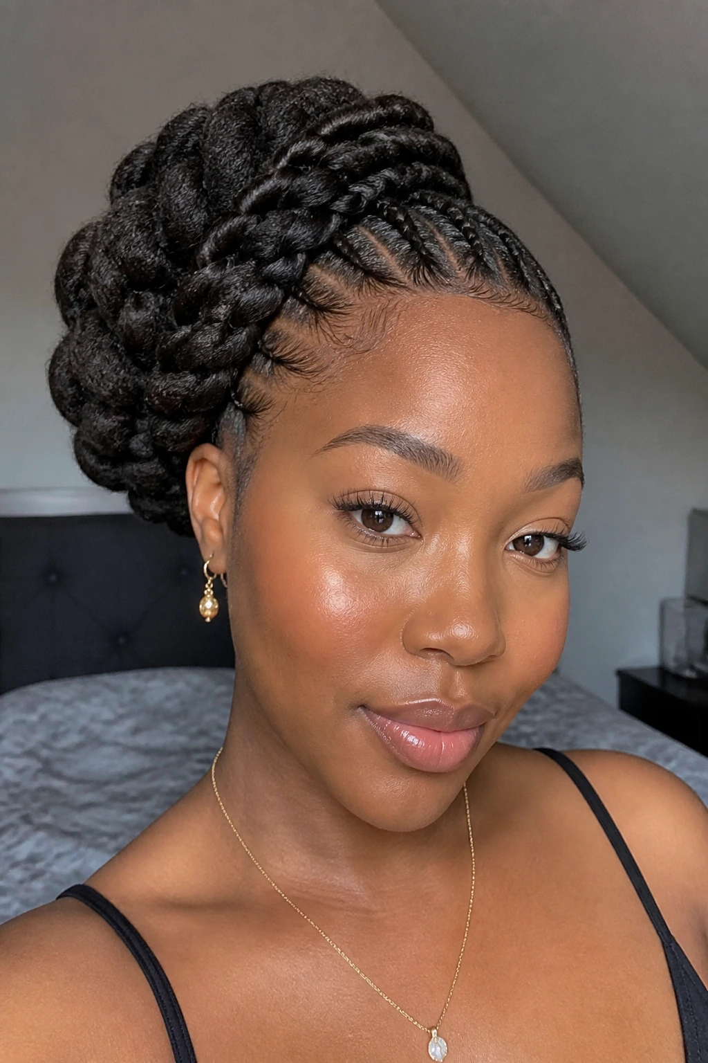 Portrait of a real person with a side-swept braided puff and tucked base