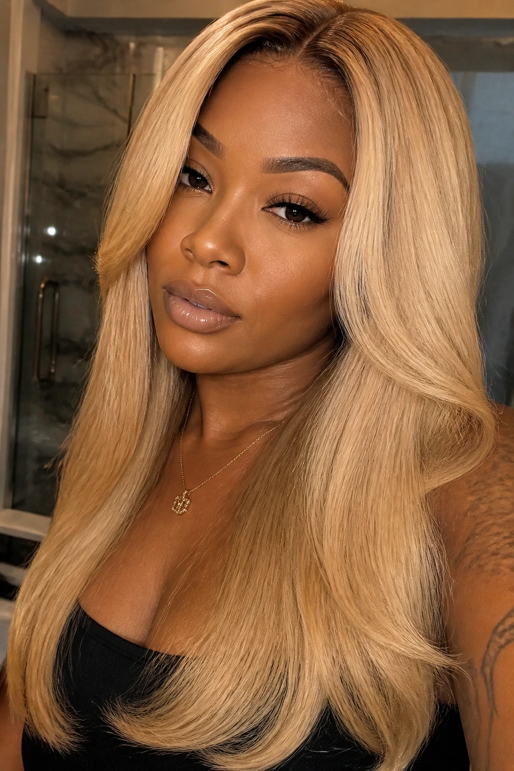 Buttery blonde silk press on a deep-skinned person