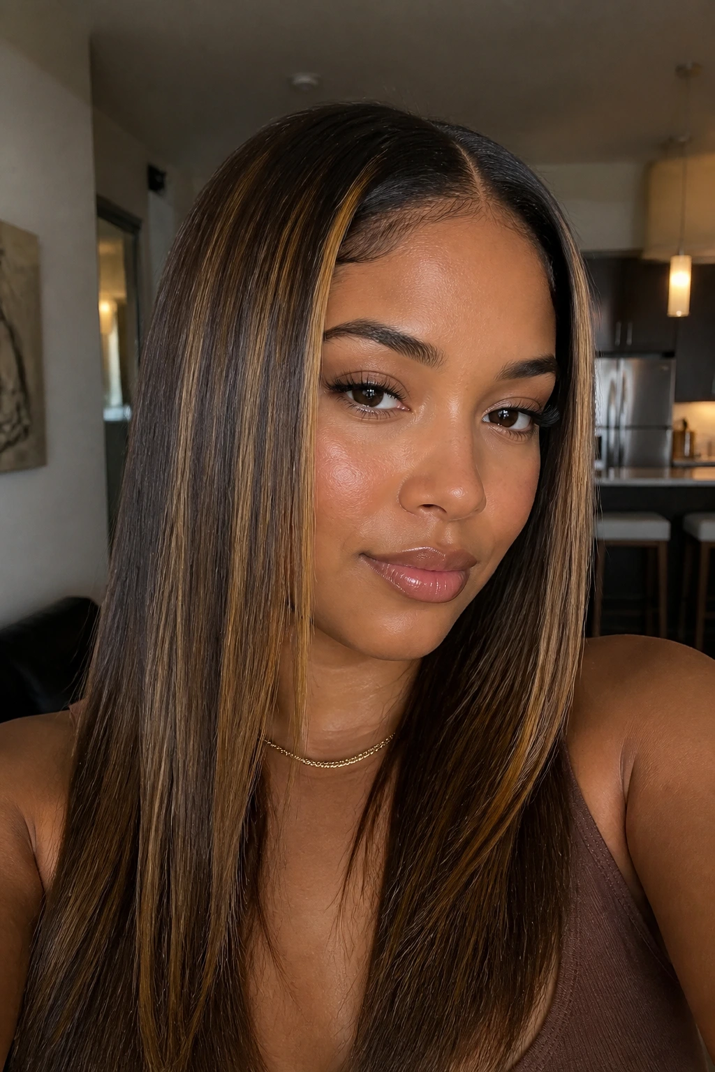 Silk-pressed straight hair with thin honey highlights around the face.