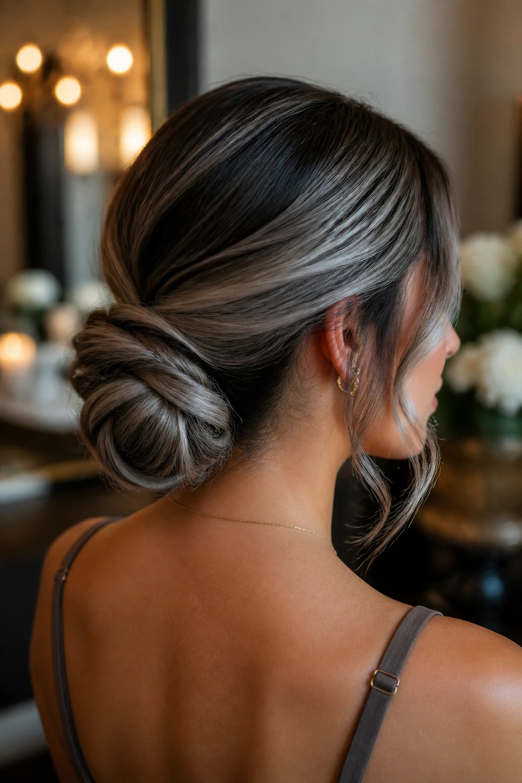 Real woman with a silver ash low knot bun