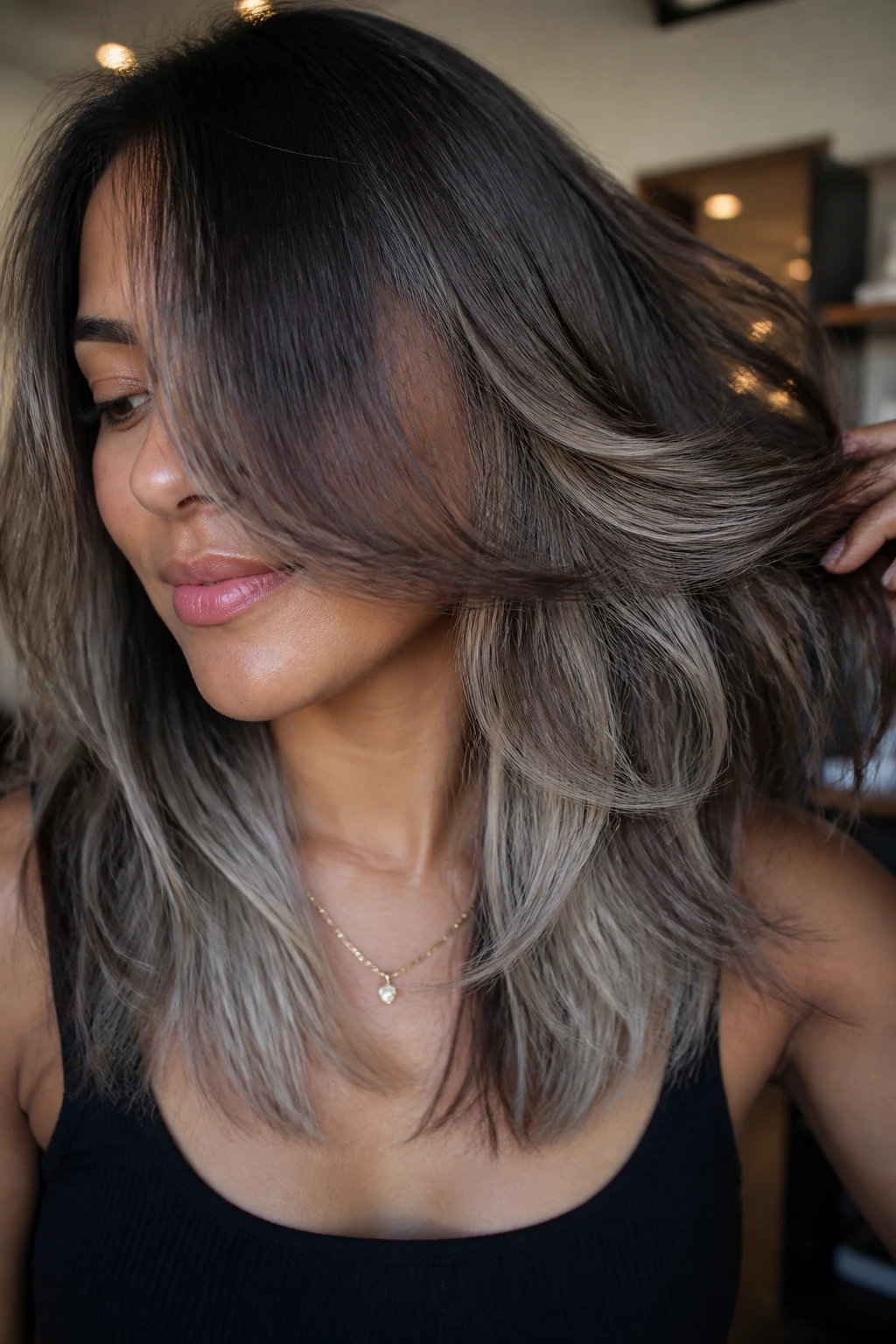 Hair with silver-beige underlights peeking from beneath top layer