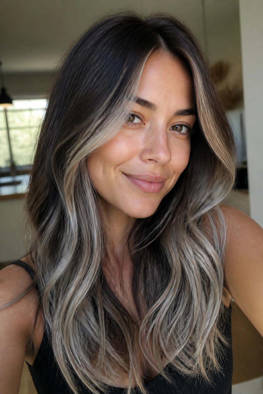 Close-up of brunette hair with silver-blonde highlights showing depth and warmth under natural light