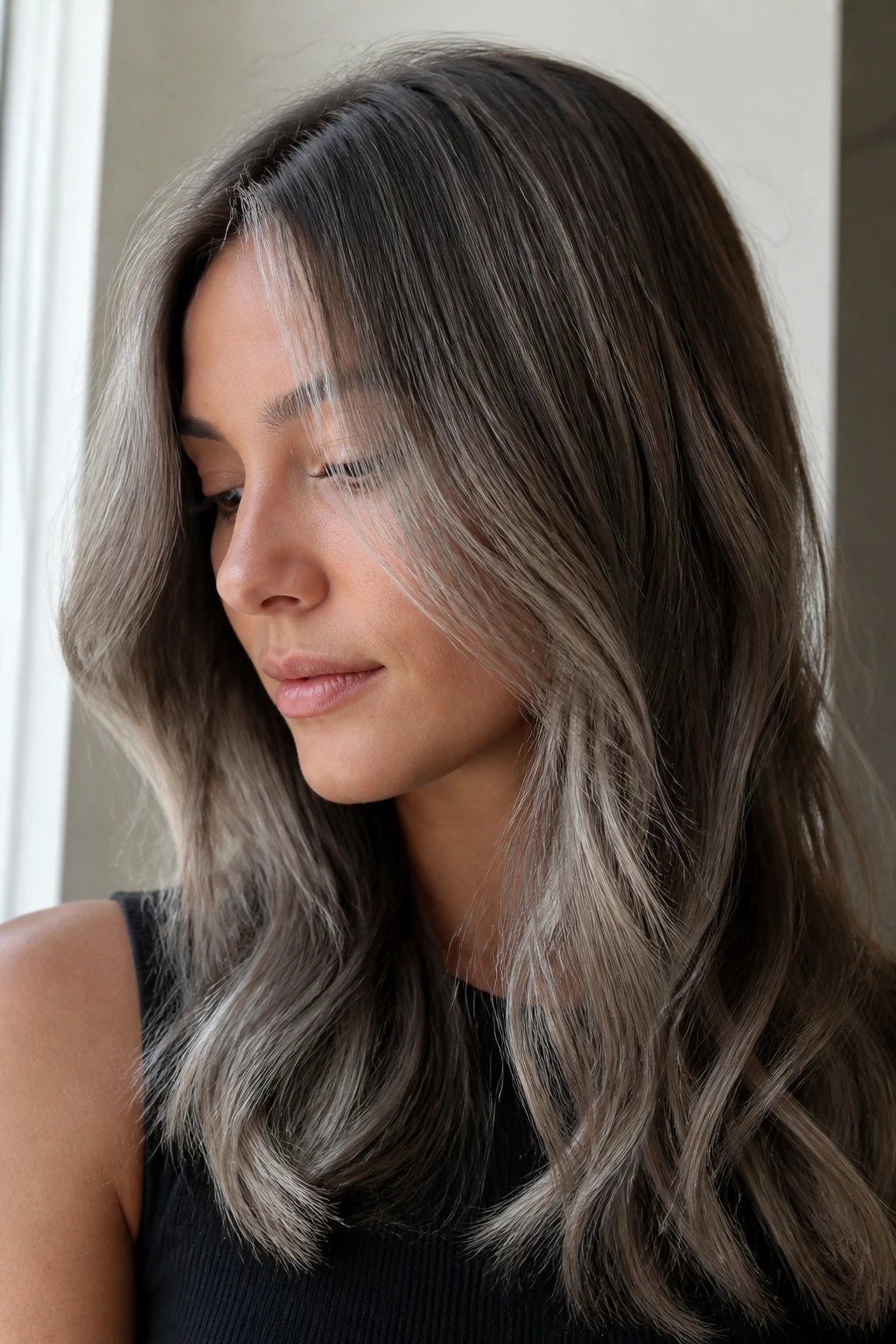 Close-up portrait of a real woman with silver fox gloss on soft brown hair
