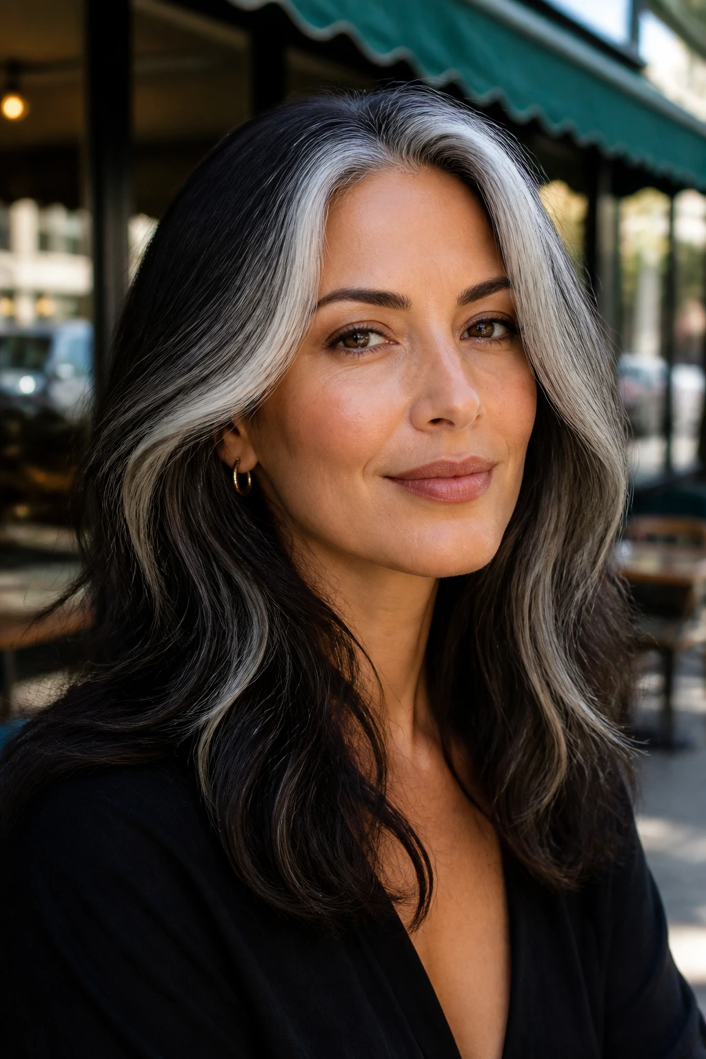 Close-up of a real person with a silver money piece at hairline on olive skin
