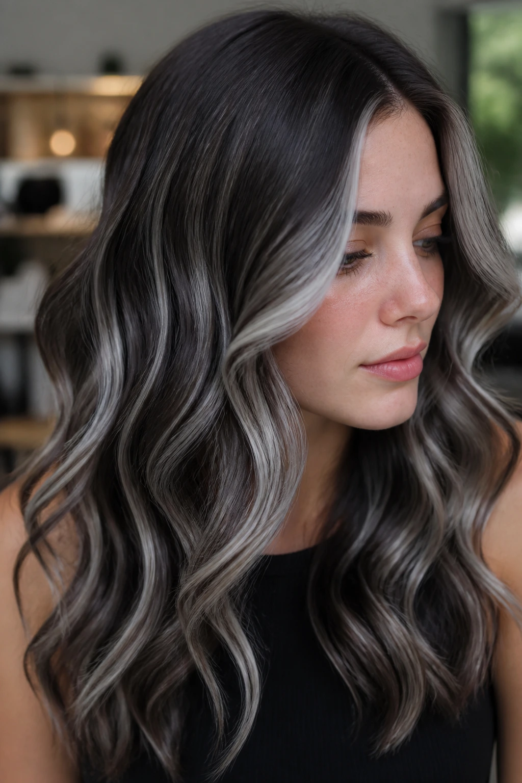 Close-up portrait with silver ribbon teasylights through dark hair.