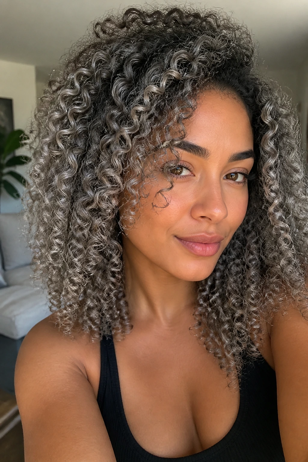 Close-up of a real person with tight ringlets and silver-tea highlights on tan skin
