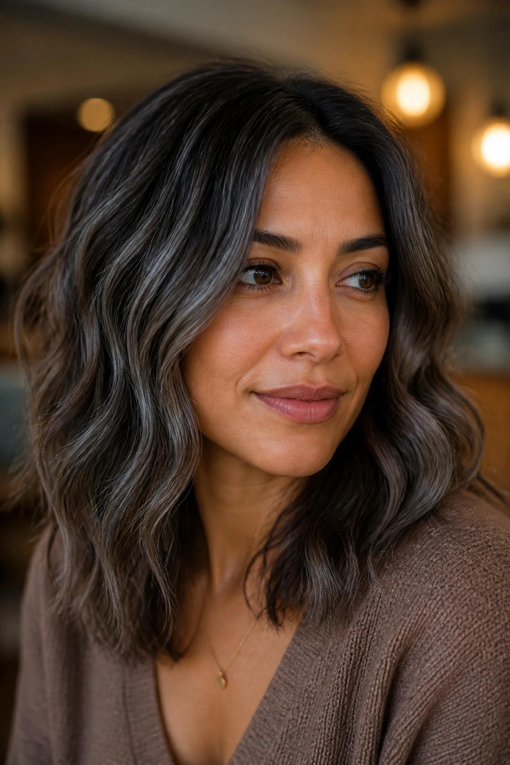 Close-up of a person with medium skin and slate brown blend hair