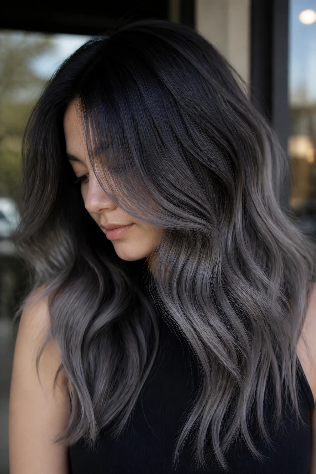 Real woman with slate ombré hair transitioning from dark roots to slate ends
