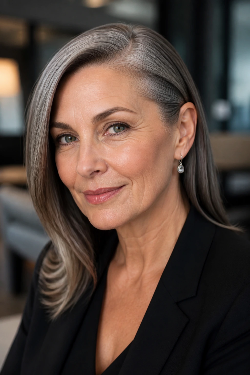 Close-up of a real woman with a sleek side part tucked behind one ear