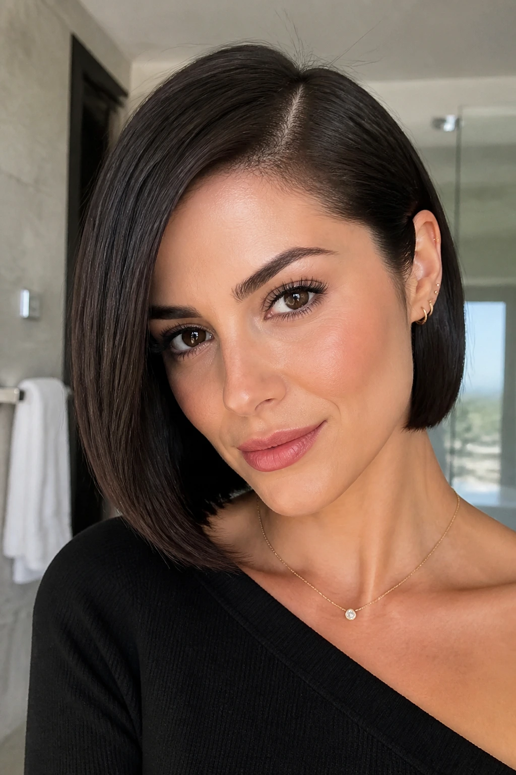 Close-up portrait of a real woman with a glossy side-parted sleek bob.