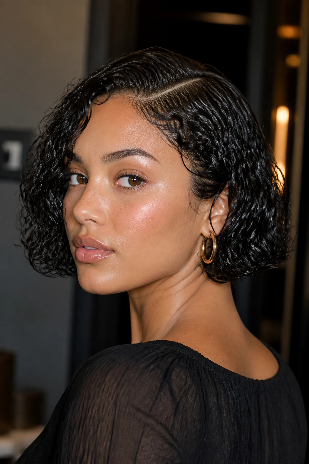Portrait of a real woman with a sleek, gel-defined wet-set bob.
