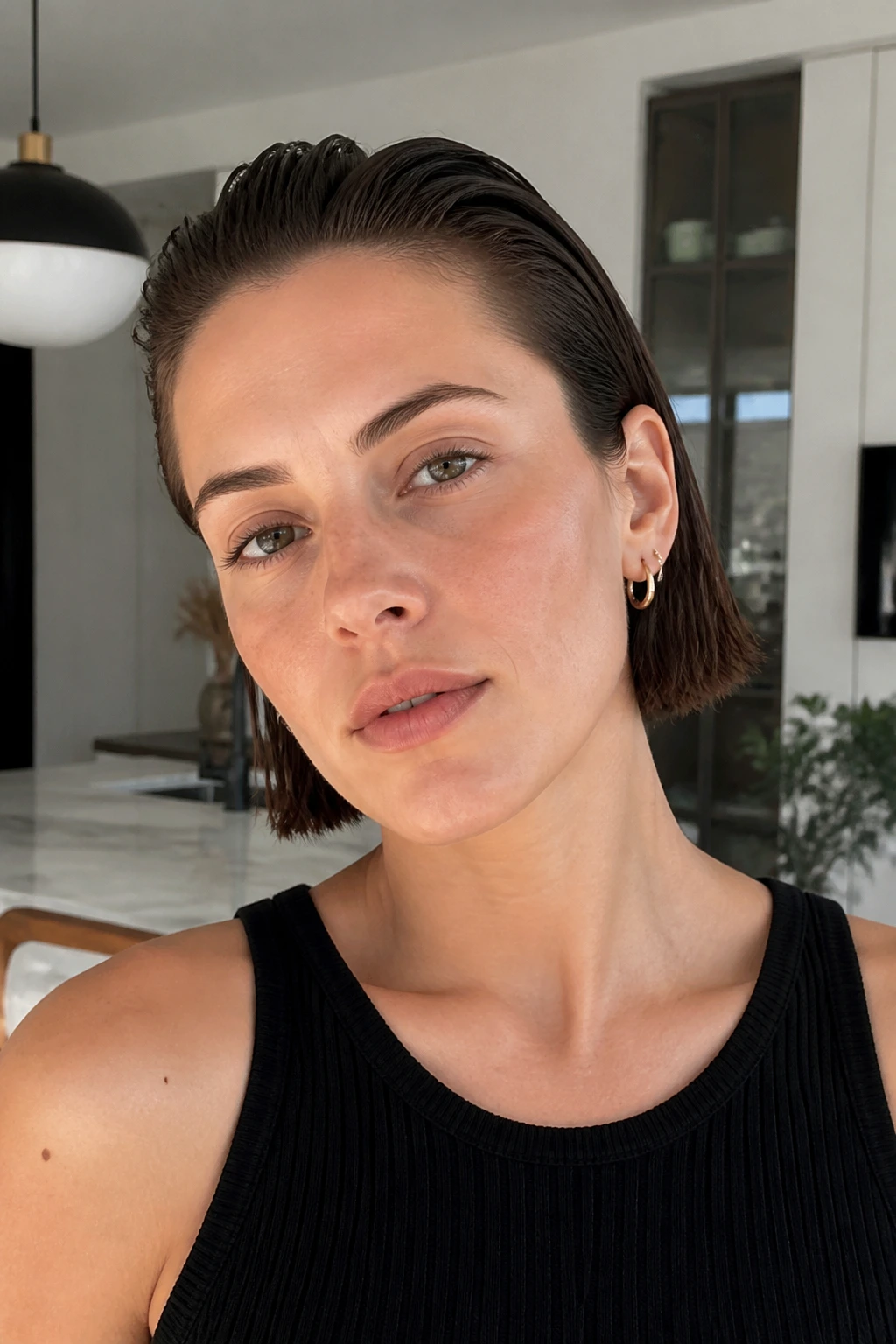 Portrait of a real woman with slicked-back minimal boyfriend bob in natural daylight