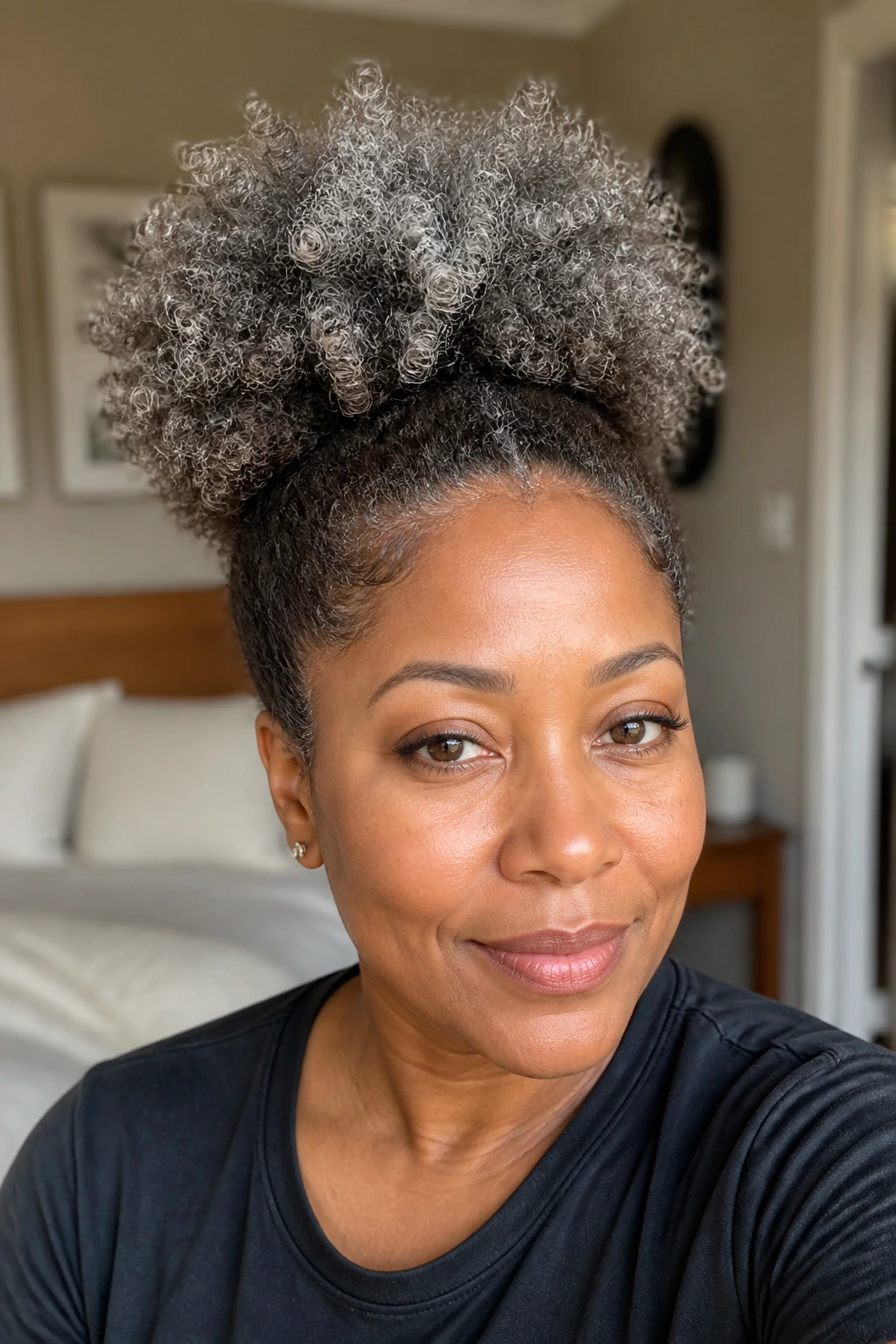 Close-up of real woman with smoke brown puff and grey ends, hair filling the frame.
