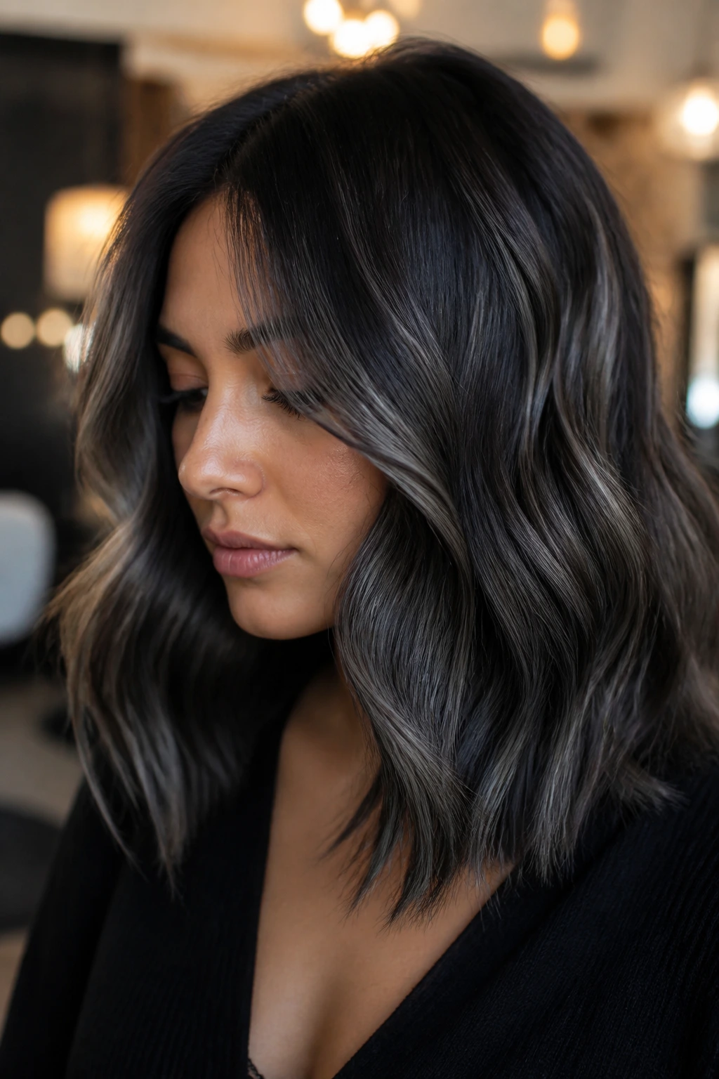 Close-up of brunette with smoky grey-black hair and ribbons