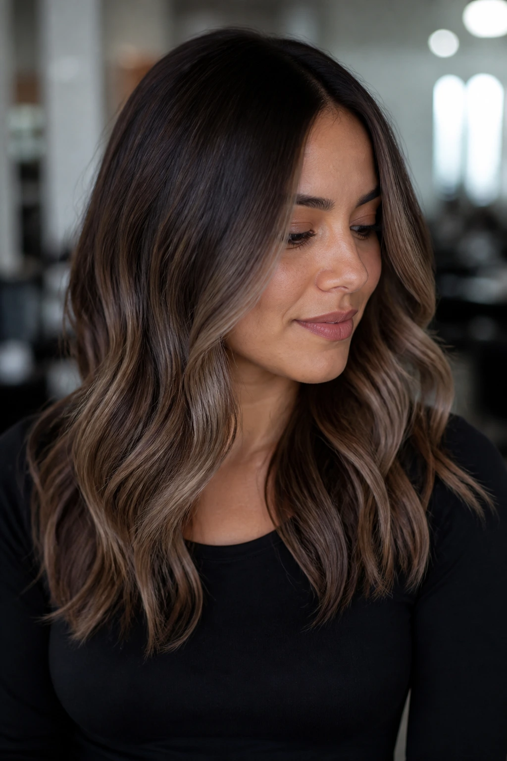 Close-up portrait of smoky ash brown balayage with a soft root on a real person