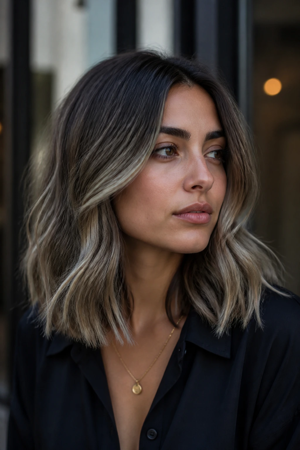 Portrait of olive-skinned woman with smoky ash balayage