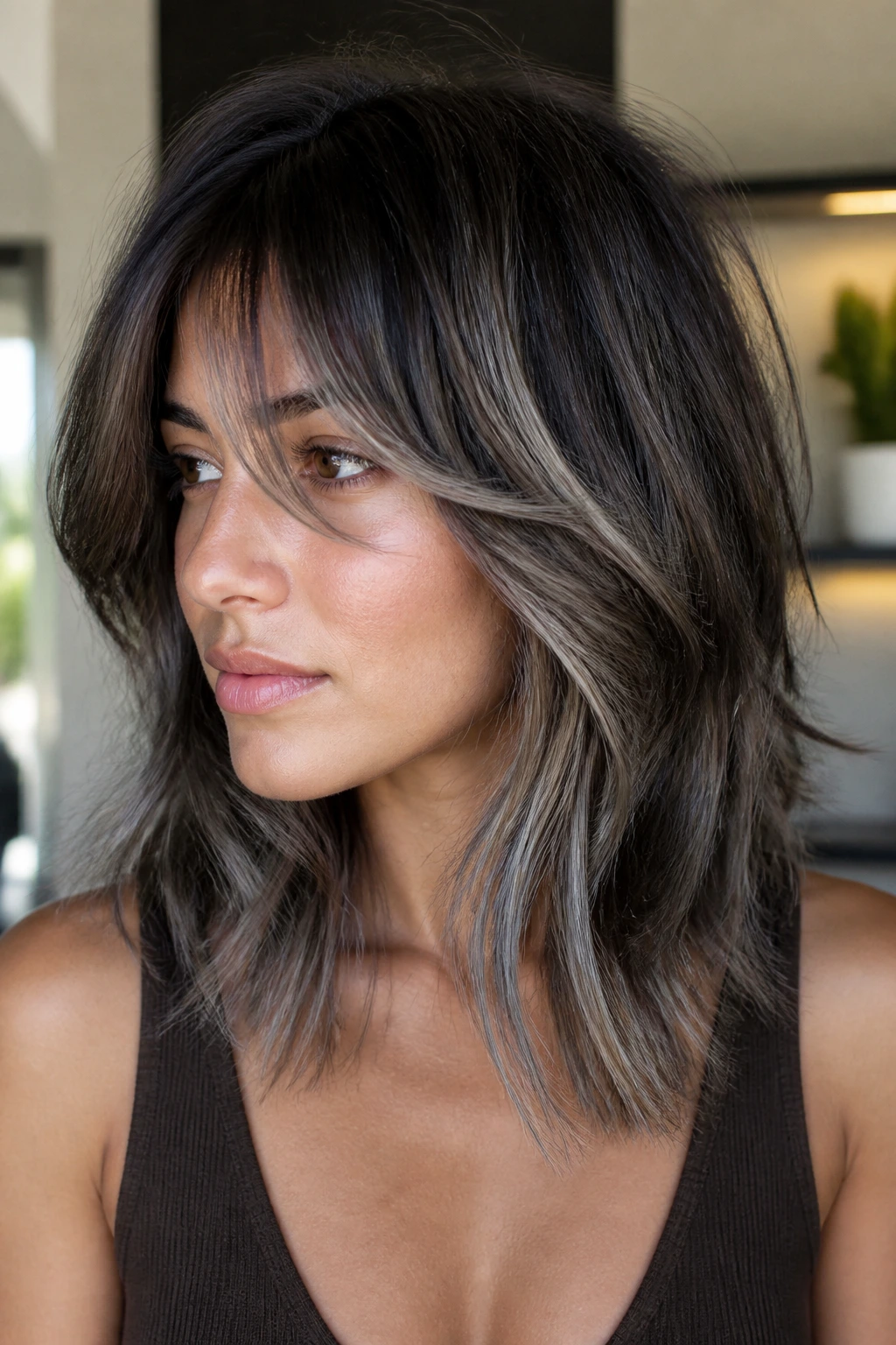 Mid-length shag with smoky ash balayage on a real person