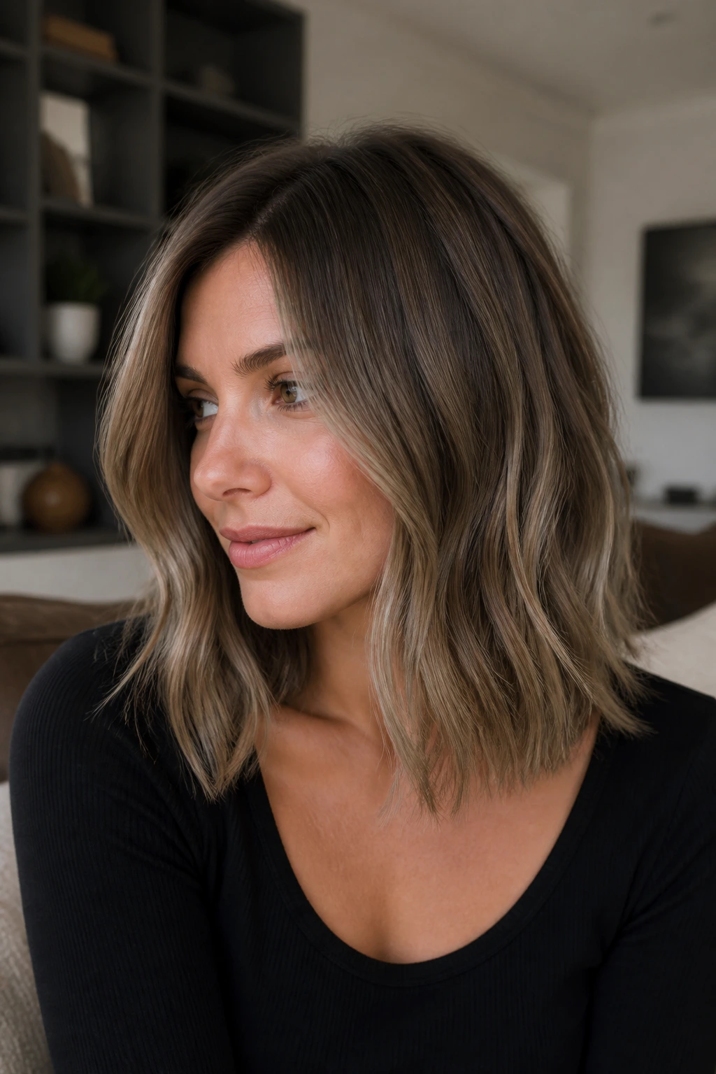 Portrait of a real person with smoky bronde lob showing muted blonde-ash-brown strands