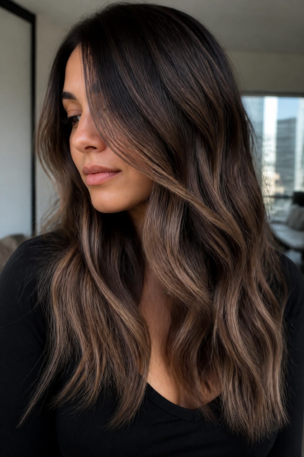 Portrait of a woman with smoky caramel melt on dark hair