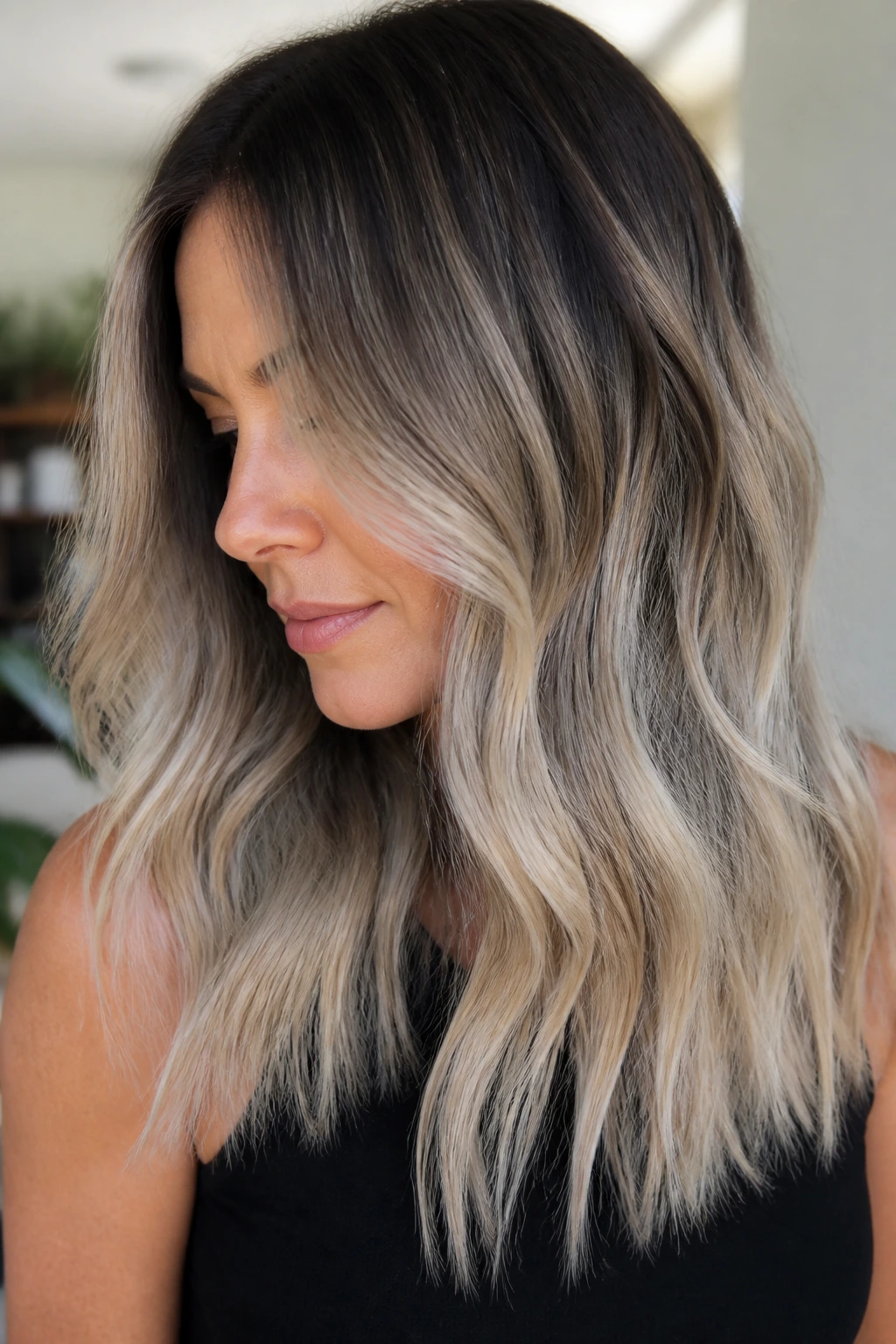 Brunette with smoky platinum balayage close-up portrait