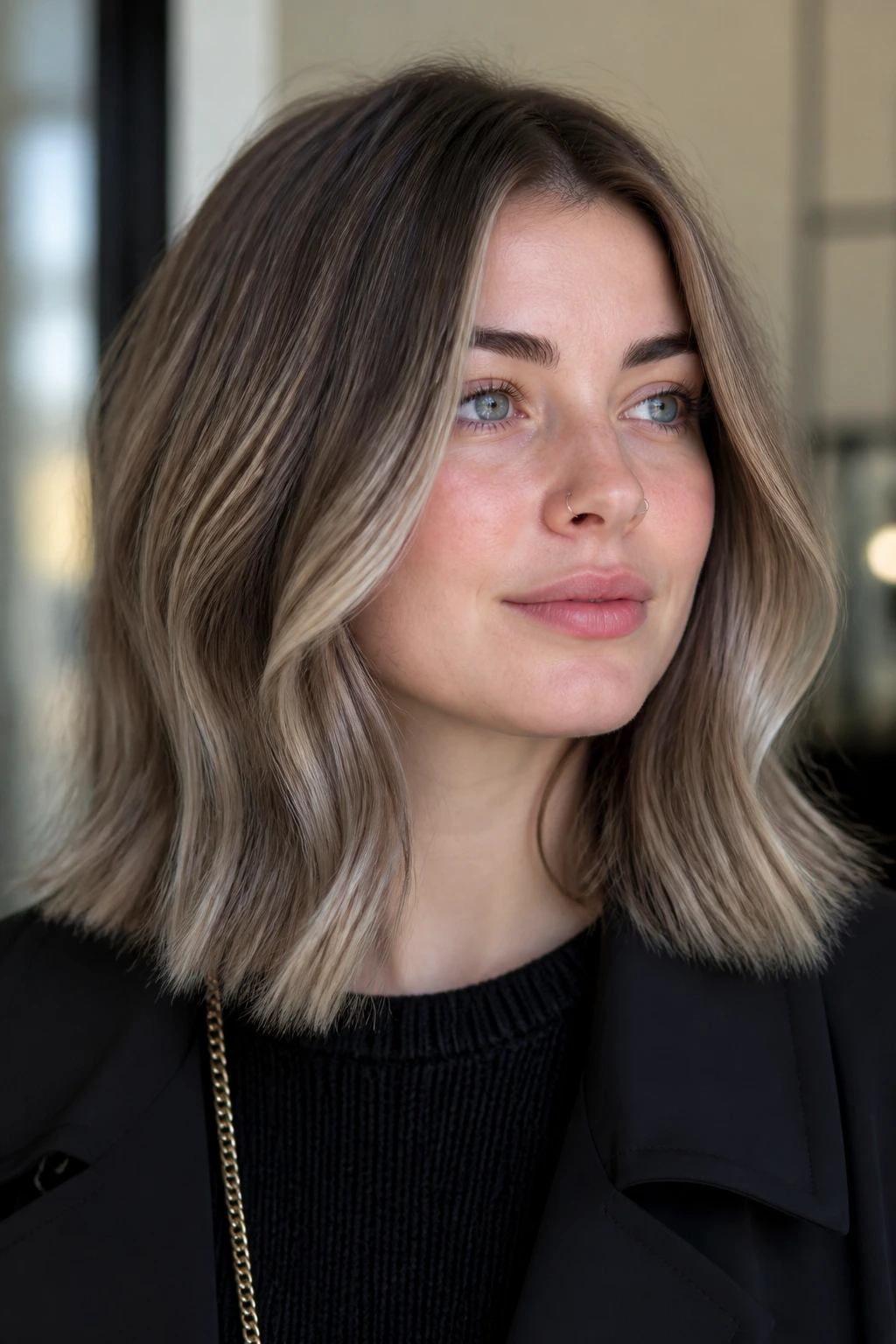Portrait of pale-skinned person with smoky taupe balayage lob