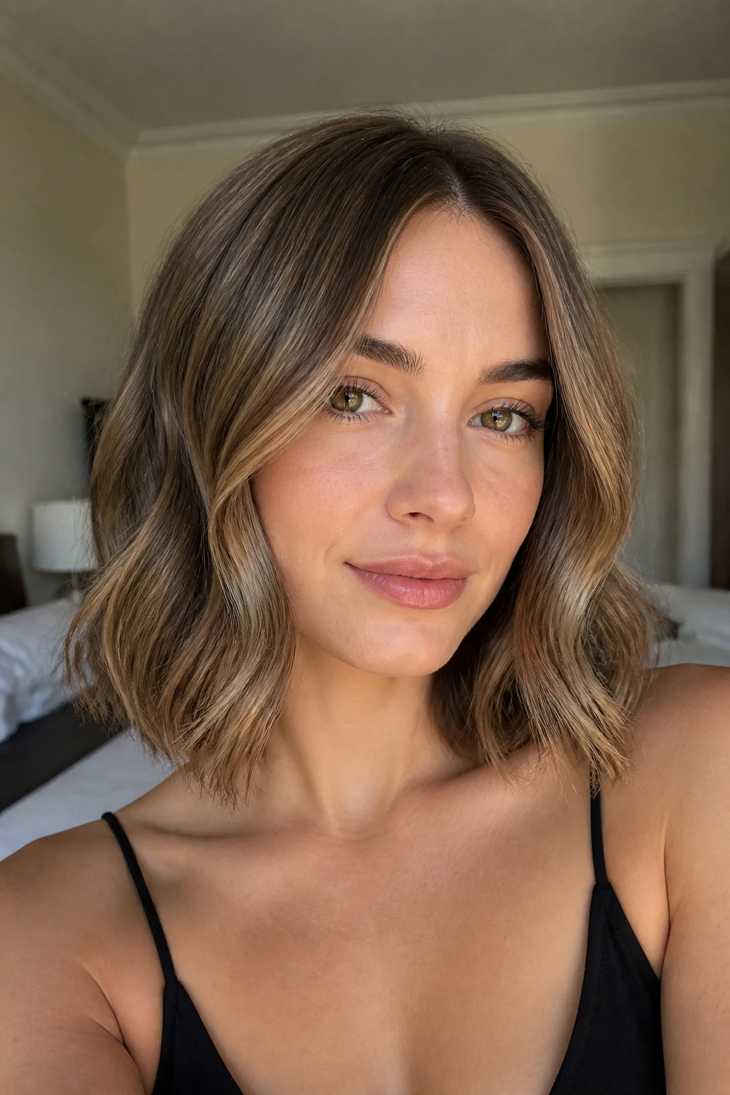 Real woman with soft collarbone-length waves created by a 1.25-inch barrel