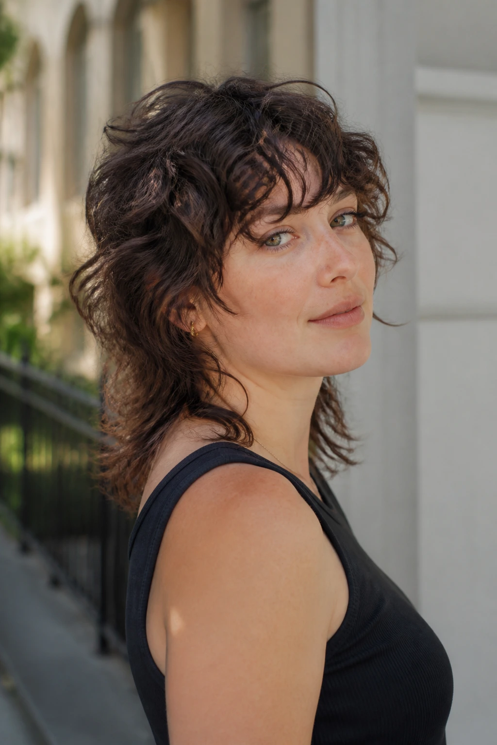 Three-quarter view of a person with a soft mullet and slim nape showing forward fringe.